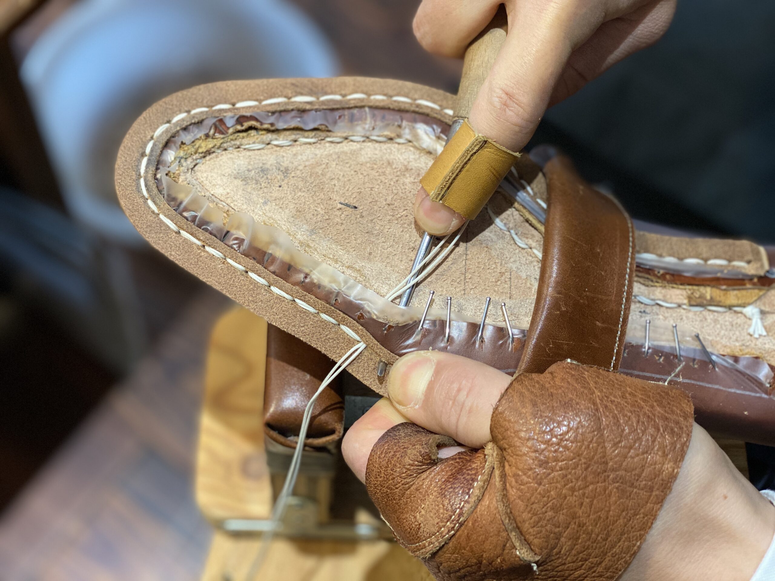 Shoe repair bench with tools for multiple dress shoe constructions