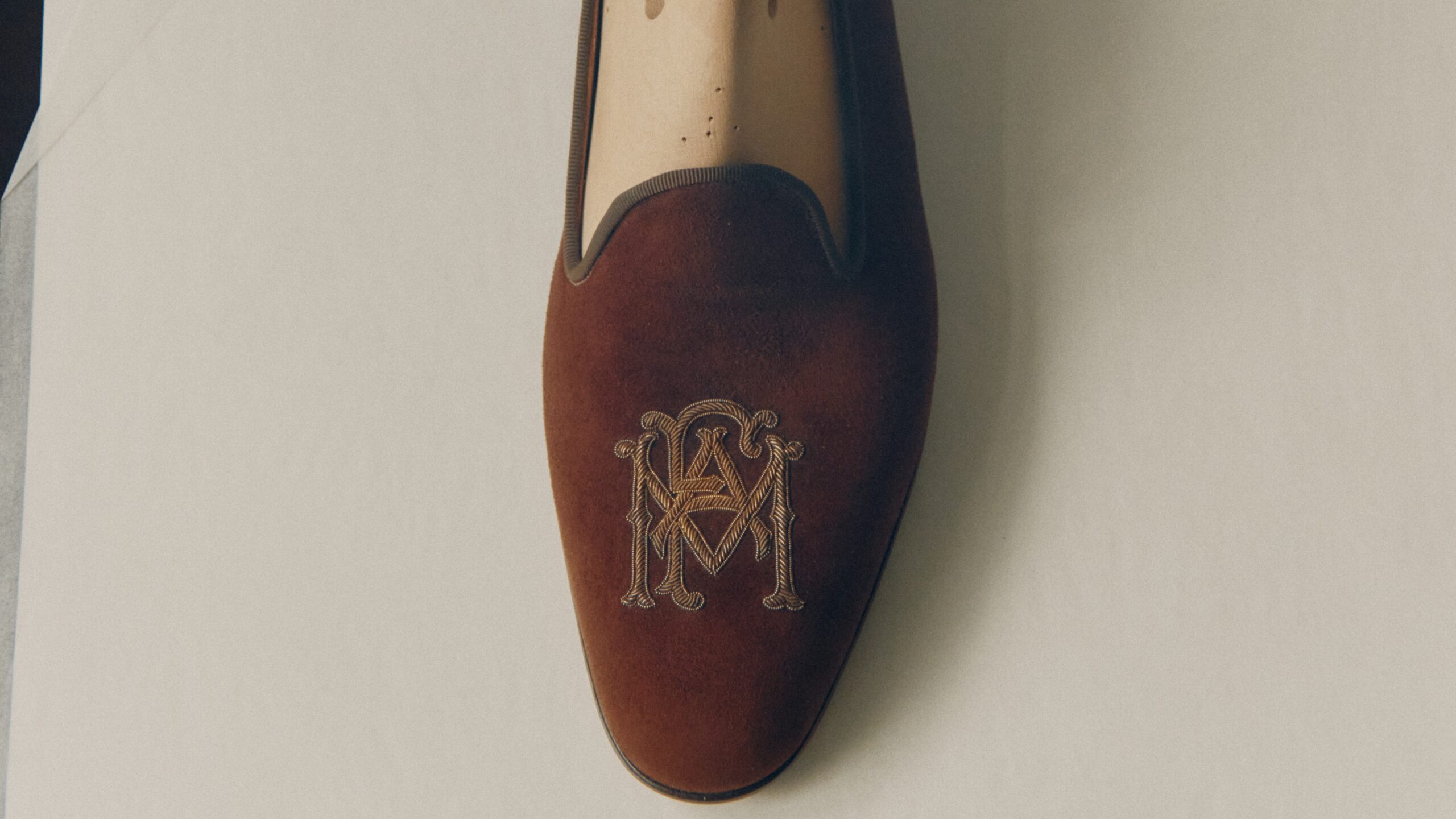 Gold-embroidered evening slipper—embodying a philosophy to craft only the best.